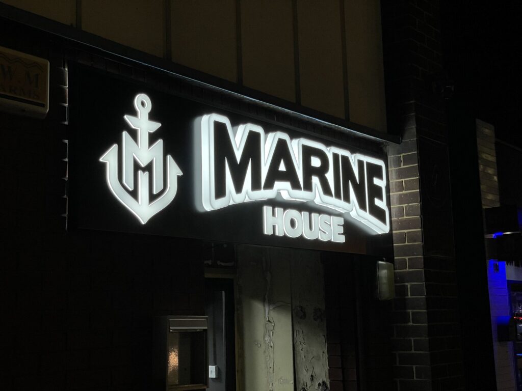 Marine House illuminated built-up letter signage at night